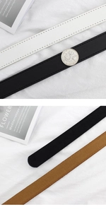 Detail view of thin minimalist belts in black, white and brown with fine stitching