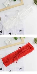 Detail of elegant floral lace waist belts in white and red with delicate leather bow ties