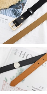 Detail of thin PU leather belts in black and brown with square gold metal buckles