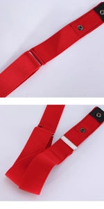 Close-up of red elastic belt featuring silver adjustable buckle and black metal snap button