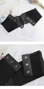 Detail of black elastic wide waist belt featuring lace-up cords and metal snap buttons