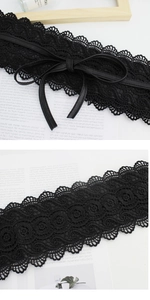 Detailed macro view of black lace floral obi belt with thin faux leather tie and ribbon