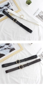Detail of vintage women's faux leather belts with gold round buckles and contrast stitching