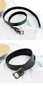 Close-up of a black leather belt for women featuring a stylish golden square buckle detail