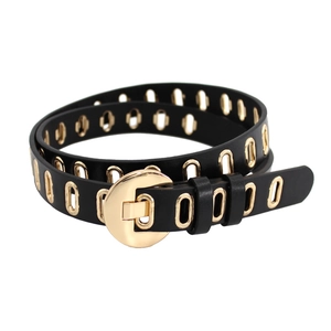 Women's black leather belt with golden oval metal eyelets and a round buckle fastening