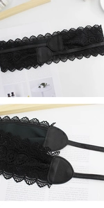 Detail of elegant black lace corset belt with faux leather texture and floral patterns