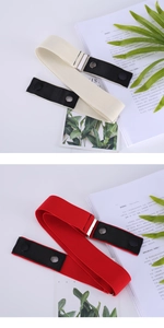 Detail of adjustable elastic belts in red and cream with black leather buckle and snap closure