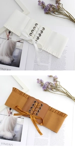 Detail of wide elastic corset belt with lace trim and elegant satin ribbon lacing