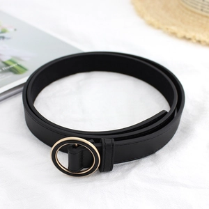 Elegant women's black PU leather thin belt with polished gold round buckle on white fabric