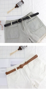 Detail of denim shorts in light blue and white with slim oval buckle leather belts