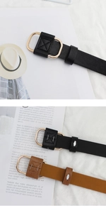Detailed close-up of slim leather belts featuring oval gold buckles in black and brown