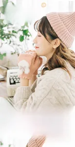 Close-up of pink knit fingerless gloves with white faux fur and cute bow detail
