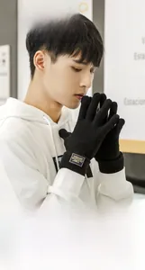 Detail of men's knitted thermal gloves showing the ribbed wrist cuff and decorative brand label