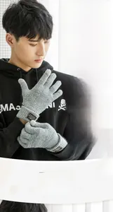 Detail of men's knitted gloves featuring thermal plush lining and touchscreen fingertips