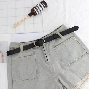 Women's light blue frayed denim shorts with minimalist black leather belt and gold buckle