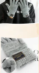 Close-up of gray knitted gloves with thermal fleece lining and stylish textile label