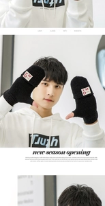 Detail of black knitted convertible mittens with branded patch for typing and warmth