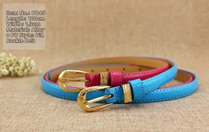 Detail of blue and pink patent leather skinny belts with engraved gold-tone buckles