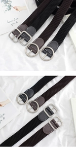 Detailed view of elastic woven belts with silver square and round buckles and stitching