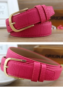 Detail of rose red lychee grain PU leather belt with gold metal D-ring buckle