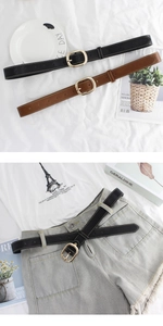 Détails de ceintures à boucle ovale tendance en noir et marron sur un short en jean