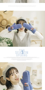 Detail of blue knit mittens with cable pattern, pink pom-poms, and cute brown ribbon bows