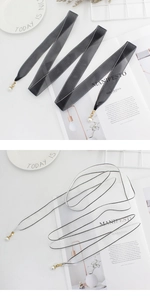 Detailed view of elegant organza waist rope belts with pearl pendants in black and white