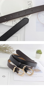 Détail de ceintures minimalistes en similicuir noir et marron avec boucles dorées