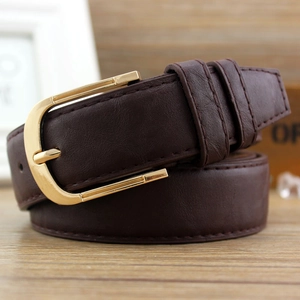 Women's dark brown PU leather belt with golden metal pin buckle on wooden background