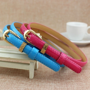 Elegant set of two thin patent leather belts in blue and pink with gold buckles