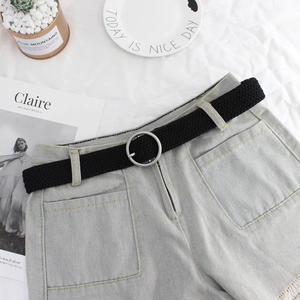 Women's light blue denim shorts with a black woven elastic belt and round silver buckle