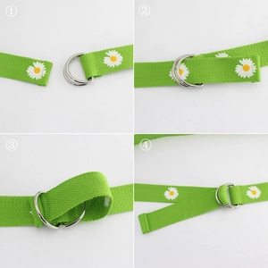 Green canvas belt with white daisy pattern and double D-ring metal buckle closure
