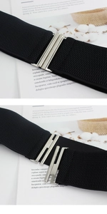 Detail of silver interlocking metal buckle and black elastic belt for women