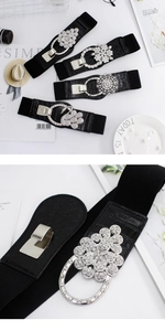 Macro view of crystal flower buckle and crocodile texture leather on elastic waist belt