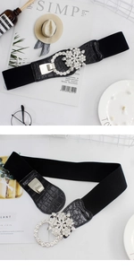 Close-up of women's elastic belt showing crocodile texture leather and rhinestone flower buckle