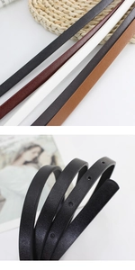 Close-up of minimalist skinny leather belts in multiple colors showing texture and holes