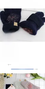 Close-up of knit winter gloves featuring plush pom-poms and snowflake patches for women