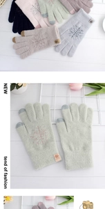 Close-up of snowflake embroidered thermal gloves with touchscreen fingertips in various colors