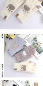 Detail of warm knit touchscreen gloves with cute bear paw prints in three pastel colors