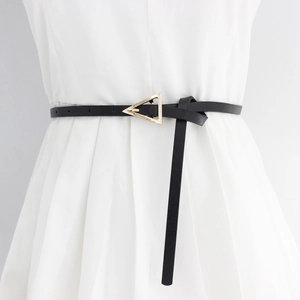 Elegant black PU leather skinny belt with golden triangle buckle on white pleated skirt