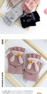 Close-up of cute knitted flip-top gloves with plush bunny ears and small yellow flowers