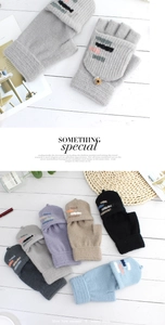 Detail of knit convertible fingerless gloves in various colors on a wooden background