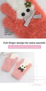 Detailed close-up of pink and white plush winter gloves with cute cartoon rabbit design