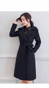 Detail of elegant black wool coat with waist-slimming belt and stylish bow tie-up knot