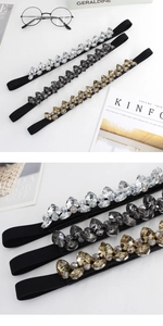 Detail shot of elastic waist belt with sparkling rhinestones in clear and grey tones
