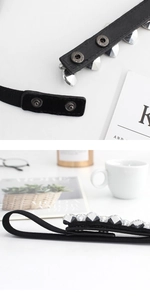 Detailed close-up of crystal rhinestones and snap button closure on a black elastic belt