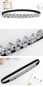 Close-up of black elastic belt featuring sparkling heart and marquise crystal rhinestones