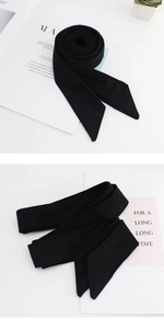 Detail of a black wool-blend belt with pointed ends for women's winter coats and trench coats