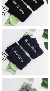 Detail showing knit flip top gloves with stripe pattern and button in black, navy, and grey