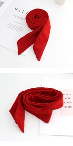 Detailed close-up of a premium red velvet belt showing fine stitching and diagonal ends